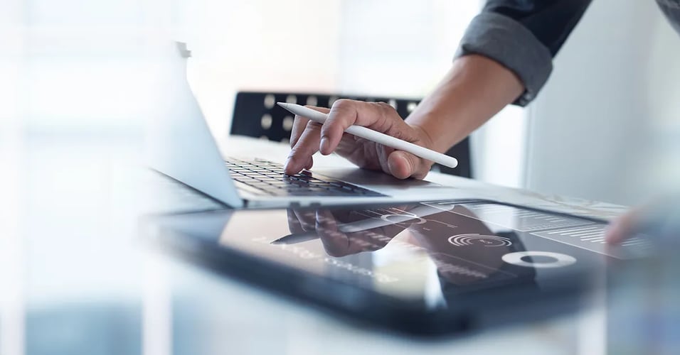 Hand typing on laptop computer.